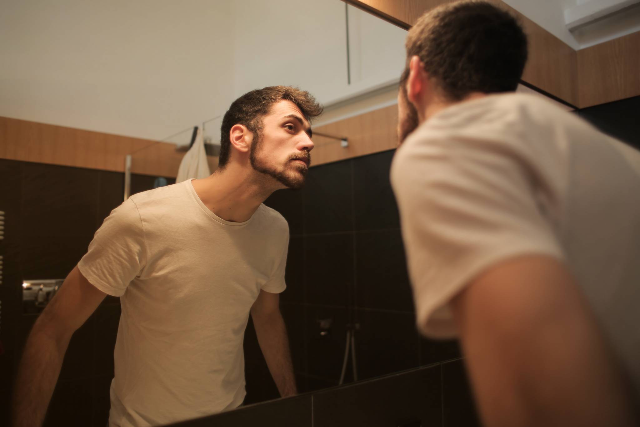 młody mężczyzna przegląda się w lustrze po goleniu